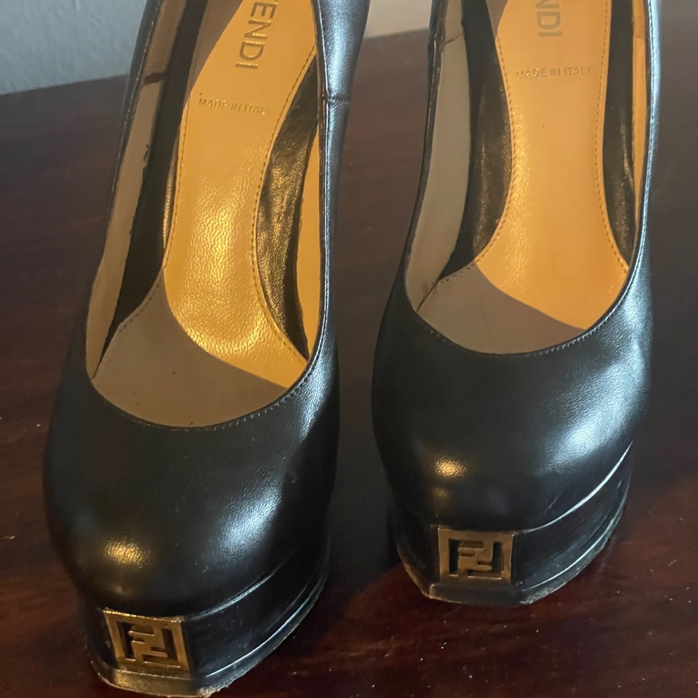 Black platform pumps with rounded toe and gold. Hardware